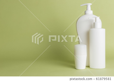 White plastic soap dispensers and deodorant. Copy space. Place for text. 61879581