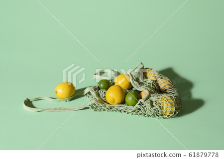 Reusable bag with lemons and limes. Food shopping. Reusable bag with lemons and limes. Food shopping. 61879778