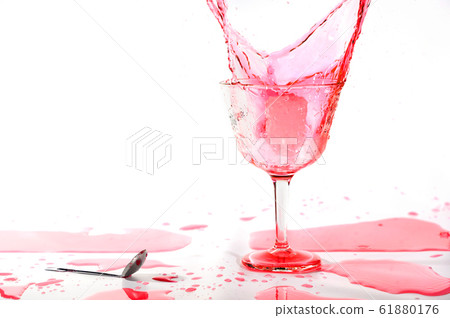 Red alcohol cocktail drink splash on white background. 61880176