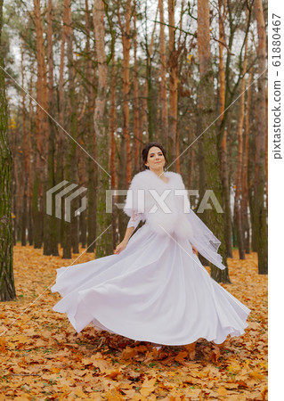 Happy beautiful bride in the autumn in the forest. Happy beautiful bride in the autumn in the forest. 61880467
