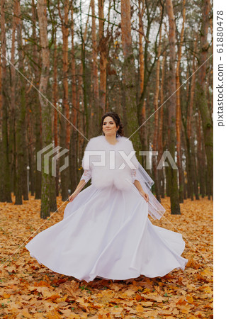 Happy beautiful bride in the autumn in the forest. Happy beautiful bride in the autumn in the forest. 61880478