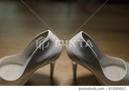 Shoes of the bride with wedding rings. Happy Shoes of the bride with wedding rings. Happy 61880602