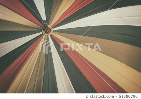 Abstract vintage background of old multicolored umbrella with texture Abstract vintage background of old multicolored umbrella with texture 61880796