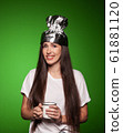Attractive young woman wearing tinfoil hat for protection. Conspiracy theory concept. 61881120