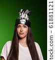 Attractive young woman wearing tinfoil hat for protection. Conspiracy theory concept. 61881121