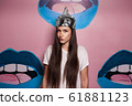 Attractive young woman wearing tinfoil hat for protection. Conspiracy theory concept. 61881123
