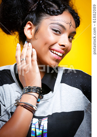 Beautiful african american girl with an afro hairstyle smiling Beautiful african american girl with an afro hairstyle smiling 61882089