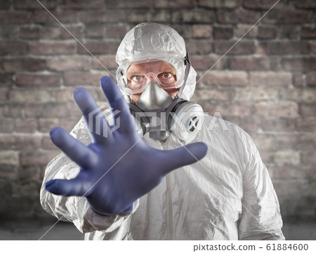 Man Wearing Hazmat Suit, Goggles and Gas Mask Man Wearing Hazmat Suit, Goggles and Gas Mask 61884600