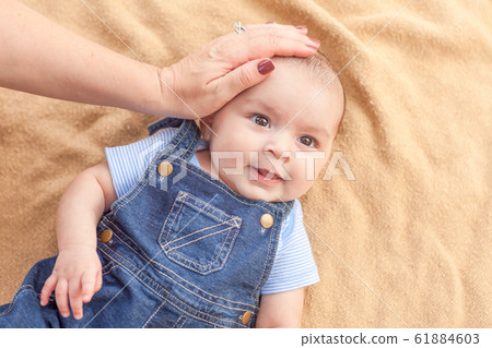 Happy Mixed Race Baby Boy Laying on Blanket 61884603