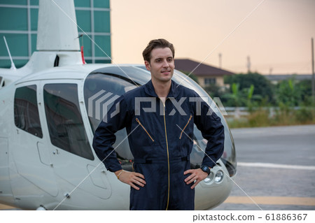 Commercial man pilot in technician suit standing Commercial man pilot in technician suit standing 61886367