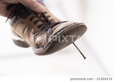 The back of a shoe stuck with an iron nail 61888419