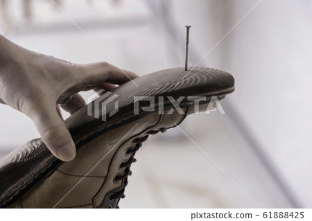 The back of a shoe stuck with an iron nail The back of a shoe stuck with an iron nail 61888425