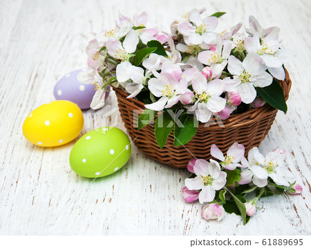 Basket with blossom and easter eggs Basket with blossom and easter eggs 61889695