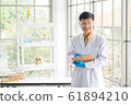 Science, Chemistry, Technology, Biology and Laboratory concept - Portrait of Asian senior scientist is taking note of an experimental result in his laboratory. 61894210