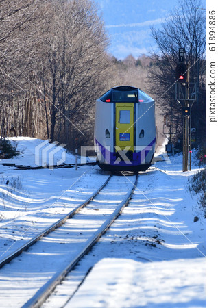 Photographing the scenery of a limited express train passing through Akaigawa Station in Morimachi, Hokkaido in winter 61894886