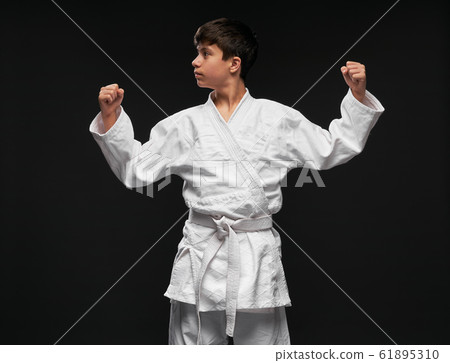 sport concept - a teenager dressed in martial arts sport concept - a teenager dressed in martial arts 61895310