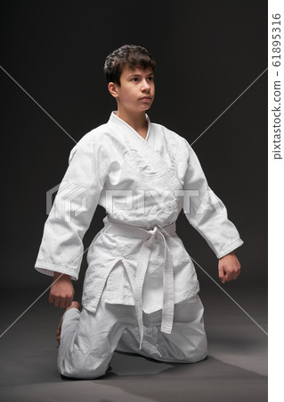 sport concept - a teenager dressed in martial arts sport concept - a teenager dressed in martial arts 61895316
