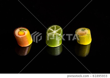Natural handmade caramel candies with fruit pattern. Macro 61895933