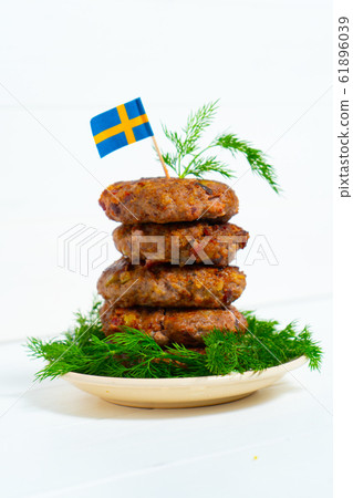 Traditional Swedish dish beef Lindstrom. In the plate with dill. Swedish flag. Swedish cuisine. Scandinavian Traditional Swedish dish beef Lindstrom. In the plate with dill. Swedish flag. Swedish cuisine. Scandinavian 61896039