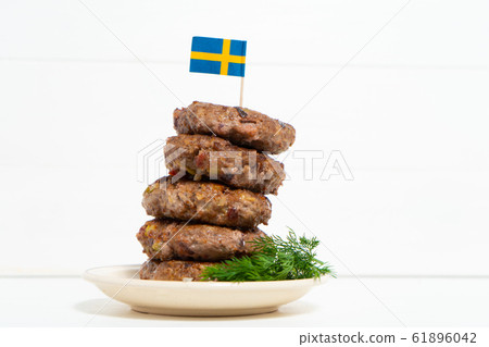 Traditional Swedish dish beef Lindstrom. In the plate with dill. Swedish flag. Swedish cuisine. Scandinavian Traditional Swedish dish beef Lindstrom. In the plate with dill. Swedish flag. Swedish cuisine. Scandinavian 61896042