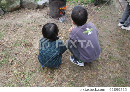 Children warming by bonfire Children warming by bonfire 61899213