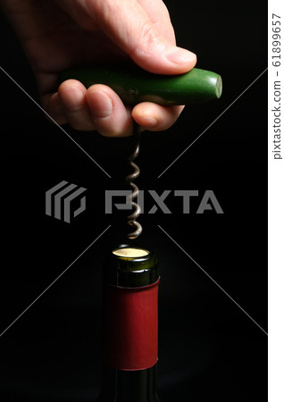 Wine Bottle And Corkscrew Isolated On Black 61899657