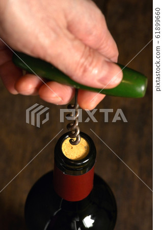 Wine Bottle And Corkscrew Isolated On Black 61899660