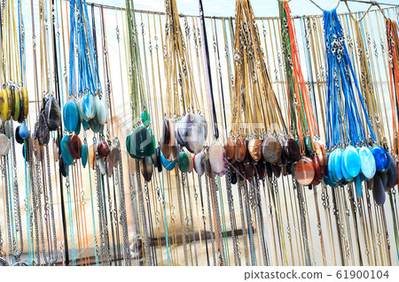 Lot of gemstone pendants sale on street market Lot of gemstone pendants sale on street market 61900104