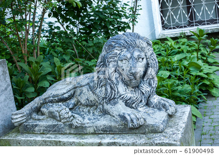 Old grunge lion statue on Lviv city street, Old grunge lion statue on Lviv city street, 61900498