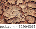 Cracks in the dried soil. Erosion. Aged photo. 61904395