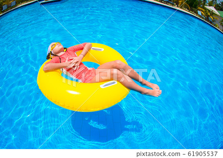 Happy kid with inflatable rubber circle having fun on the beach Happy kid with inflatable rubber circle having fun on the beach 61905537
