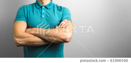 confidence and reliability. closeup crossed arms of a man on grey background with copy space confidence and reliability. closeup crossed arms of a man on grey background with copy space 61906598