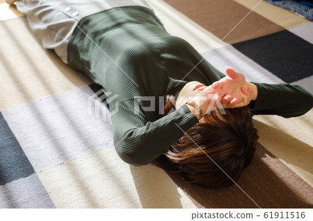 A woman lying down in the living room Break Fatigue Fatigue 61911516