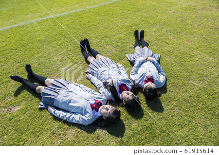 High school student lying on the lawn High school student lying on the lawn 61915614