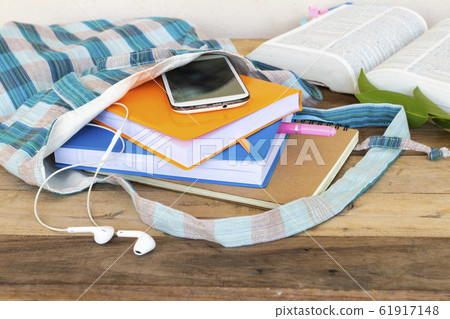 notebook ,diary and mobile phone in cloth bag with dictionary book for study of student 61917148