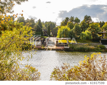 Autumn river landscape against a cloudy sky. Autumn river landscape against a cloudy sky. 61917599