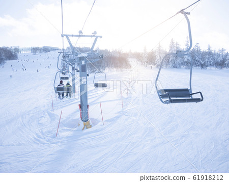 Family skiing (riding a lift) Family skiing (riding a lift) 61918212