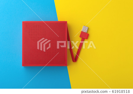 Red portable speaker on blue and yellow background Red portable speaker on blue and yellow background 61918518
