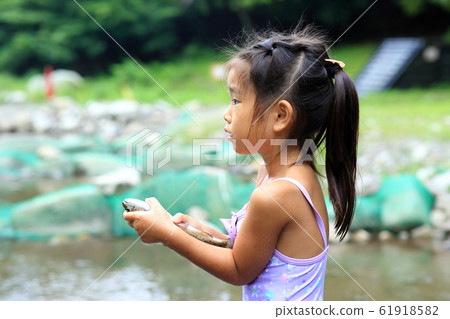Girl enjoying fishing 61918582