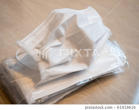 A pile of white surgical masks for flu season A pile of white surgical masks for flu season 61918616