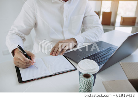 Young asian man looking on computer laptop and 61919438