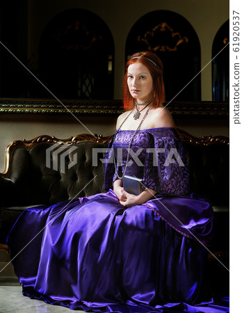 young queen is sitting on the couch 61920537