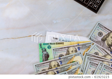 1040 Tax form with refund check and currency US 61923223