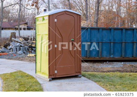 Portable restroom on house under construction in a Portable restroom on house under construction in a 61923375