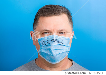 Portrait of a sick man wearing medical mask with 61923511