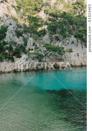 Beautiful beach with turquoise water and rocky cliffs Beautiful beach with turquoise water and rocky cliffs 61924463