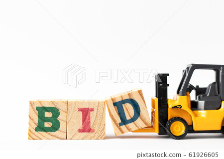 Toy forklift hold wood letter block D to complete word bid Toy forklift hold wood letter block D to complete word bid 61926605