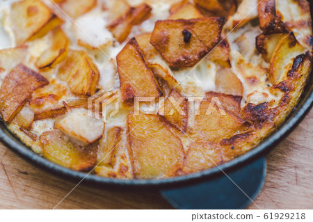 Potatoes baked with meat in the oven. Delicious dinner recipe. Potato pudding. Baked potato. Beef casserole. Potato gratin.Baked potatoes with eggs and chicken in a round bowl on a wooden table 61929218