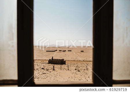Abandoned buildings left to rot in wild west scenery with desert sand Abandoned buildings left to rot in wild west scenery with desert sand 61929719