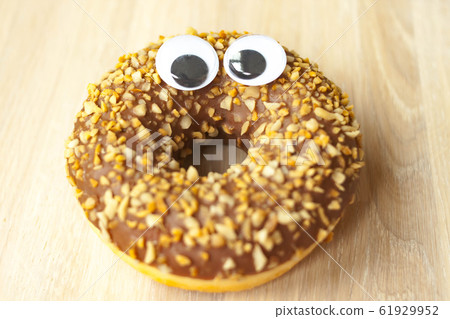 Funny smiling face chocolate donut with with nut 61929952